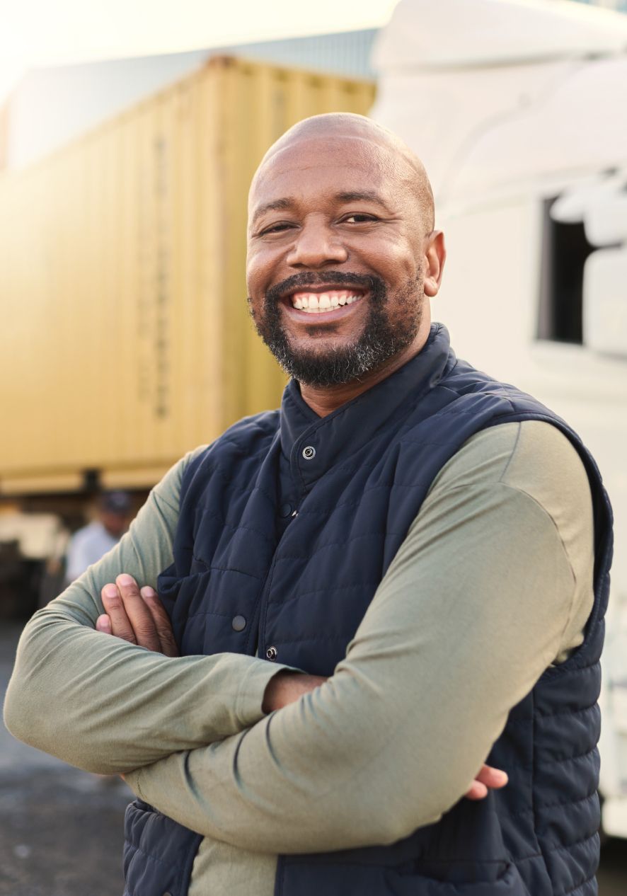 Man smiling in front of semi truck